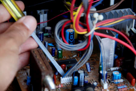 salvador, bahia / brazil - october 17, 2014: technician checking electronic television circuit board in the city of Salvador.のeditorial素材