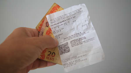 salvador, bahia / brazil - november 18, 2019: Hand holding QR code coupon Codes.のeditorial素材