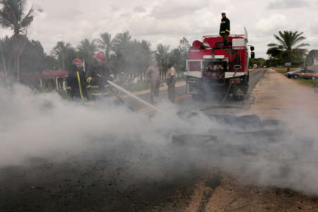 Porto Seguro, Bahia, Brazil - March 2, 2010: Member of the Fire Department puts out a fire on the BR...