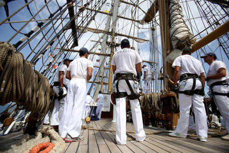 salvador, bahia, brazil - october 19, 2018: crew member of the Brazilian Navy's White Swan is seen working at the vessel in the waters of the Todos os Santos Bay, in the city of Salvador.のeditorial素材