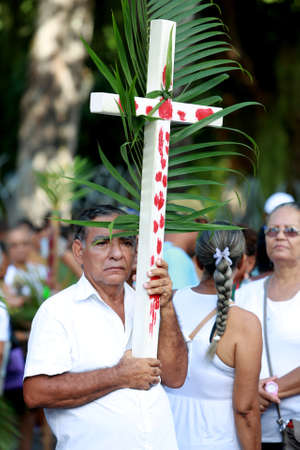 salvador, bahia, brazil - march 29, 2015: Catholics are seen carrying palm branches during...