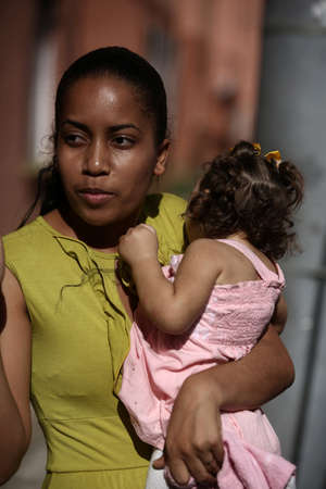 salvador, bahia, brazil - september 27, 2017: mother sucks her daughter with microcephaly caused by zica virus during pregnancy in the city of Salvador.のeditorial素材