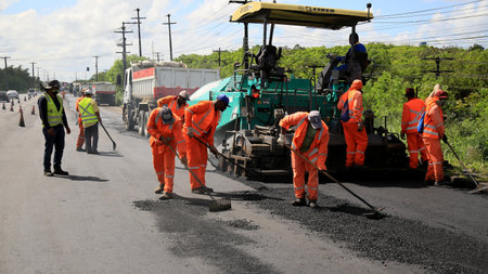 camacari, bahia, brazil - august 24, 2021: workers are seen doing an asphalt recap of the access...