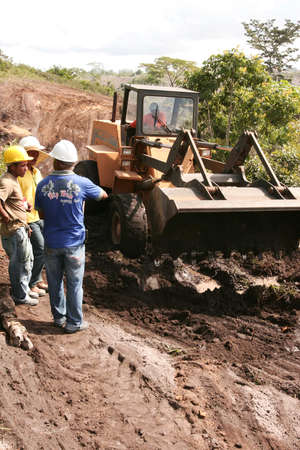 Porto Seguro, Bahia, Brazil - April 20, 2010: Tractor is seen working in a flooded area for land...