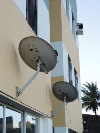 salvador, bahia, brazil - november 12, 2021: subscription TV antenna is seen attached to the facade wall of a building in the city of Salvador.のeditorial素材