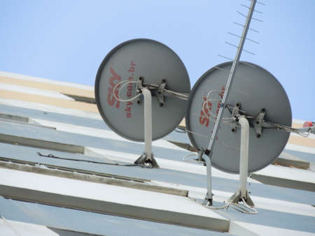 salvador, bahia, brazil - november 12, 2021: subscription TV antenna is seen attached to the facade wall of a building in the city of Salvador.のeditorial素材