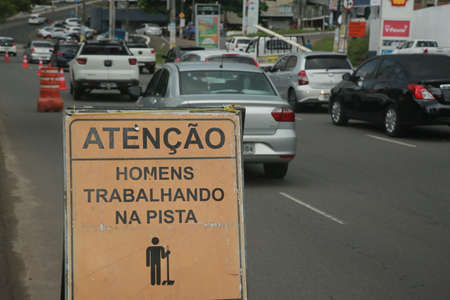 Salvador, Bahia, Brazil - November 24, 2021: Sign indicates men working near a vehicular traffic lane in the city of Salvador.のeditorial素材