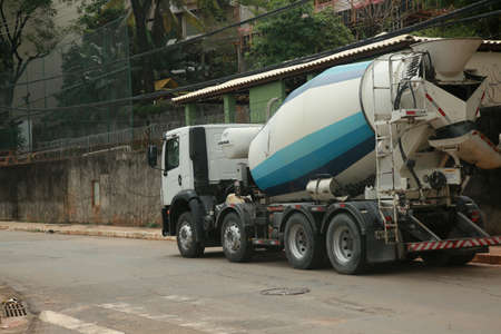 salvador, bahia, brazil - november 24, 2021: Concrete mixer truck passing through a construction area on a street in the city of Salvador.のeditorial素材