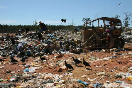 teixeira de freitas, bahia, brazil - may 5, 2008: person collecting material for recycling in a landfill in the city of teixeira de freitaのeditorial素材
