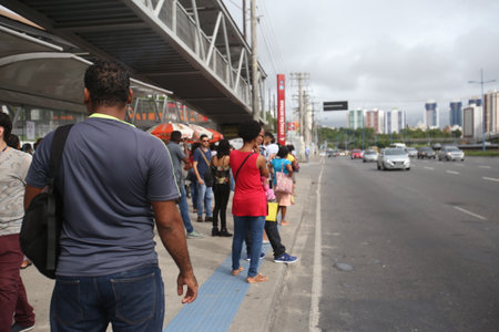 Salvador, Bahia, Brazil - April 25, 2019: Public transport users are seen at a bus stop in the city...