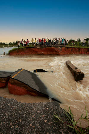 prado, bahia, brazil - april 7, 2010: people trying to cross a road destroyed due to flooding of a...