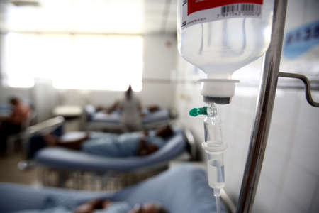 Salvador, Bahia, Brazil - October 19, 2017: Patient in hospital bed taking intravenous serum in Salvador city.のeditorial素材