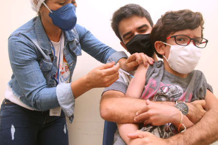 Salvador, Bahia, Brazil - February 5, 2022: Child receiving Pfiser vaccine for protection against coronavirus in Salvador cityのeditorial素材