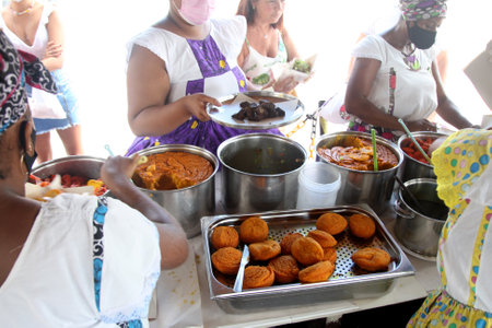 salvador, bahia, brazil - february 6, 2022: baiana prepares acaraja for sale to customers in the city of Salvadorのeditorial素材