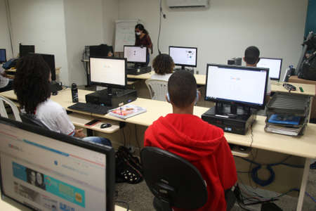 Salvador, Bahia, Brazil - February 7, 2022: Students from a public school using a computer in a computer room in the city of Salvador.のeditorial素材