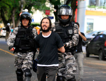 Salvador, Bahia, Brazil - June 13, 2014: Police apprehend a group of protesters against the FIFA...