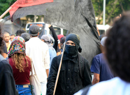Salvador, Bahia, Brazil - June 13, 2014: group of masked protesters against the fifa world cup at the protest in the city of salvador.のeditorial素材