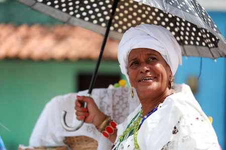 Salvador, Bahia, Brazil - January 25, 2015: devotee of candomble religion seen in front of the...
