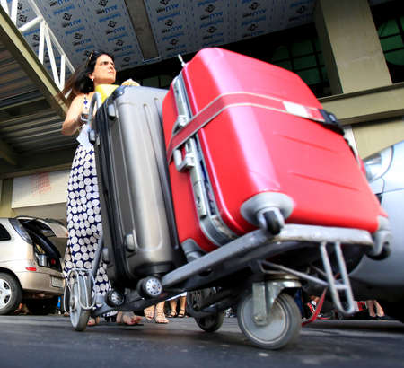 Salvador, Bahia, Brazil - February 3, 2016: Passengers carrying travel bag at airport in Salvador city.のeditorial素材