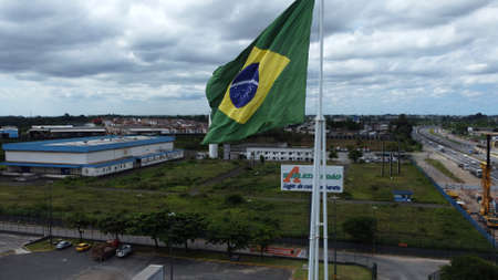 Salvador, Bahia, Brazil - April 11, 2022: Brazilian flag on a flagpole of a supermarket in the city of Salvador.のeditorial素材
