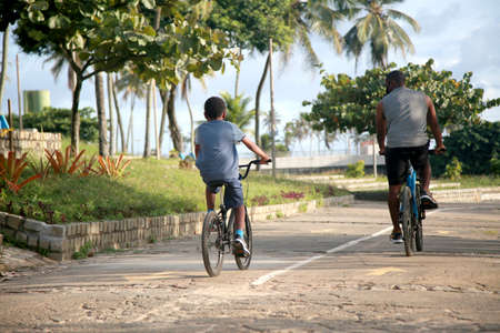 Salvador, Bahia, Brazil - January 27, 2022: People riding bicycles on a bike path in the Metropolitan Park of Piatuacu in the city of Salvador.のeditorial素材