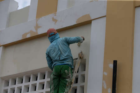 ipira, bahia, brazil - june 10, 2022: wall painter does his work in renovating a house in the city of Ipira.のeditorial素材