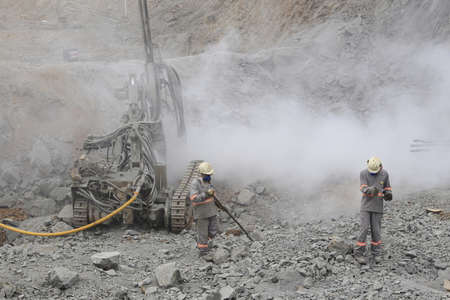 ilheus, bahia, brazil - may 23, 2022: workers with a rock drilling machine in a road construction in...