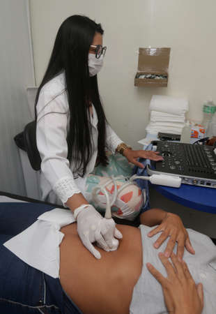 ipira, bahia, brazil - june 10, 2022: a doctor performs an ultrasound exam on a patient during a health care fair in the city of Ipira.のeditorial素材