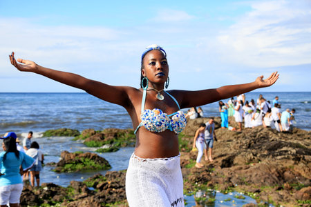 salvador, bahia, brazil - february 2, 2023: Candoble supporters and Orixa Iemanja supporters visit Rio Vermelho beach in Salvador, during festivities in honor of the Queen of the Sea.のeditorial素材