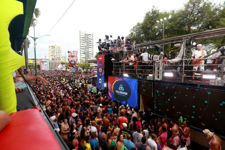 salvador, bahia, brazil - february 22, 2023: revelers are seen next to a trio eletrico during the canaval in the city of Salvador.のeditorial素材