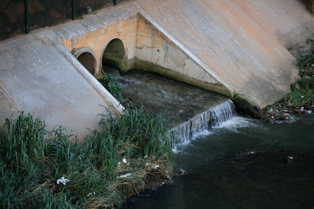 Salvador, Bahia, Brazil - May 17, 2023: Pipe gushing sewage water into a stream in the city of...