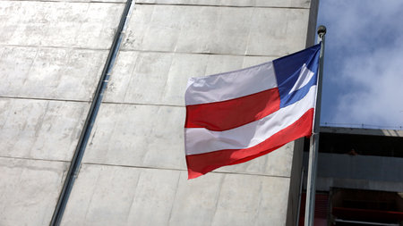 salvador, bahia, brazil - august 30, 2023: Flag of the State of Bahia is seen on a flagpole in the city of Salvador.の写真素材