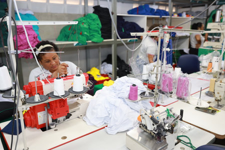 salvador, bahia, brazil - june 7, 2024: seamstress working in a textile factory in the city of Salvador.のeditorial素材