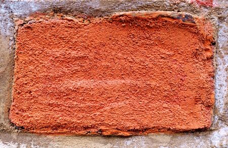 Surface of red brick embedded into the wall - in close-upの写真素材