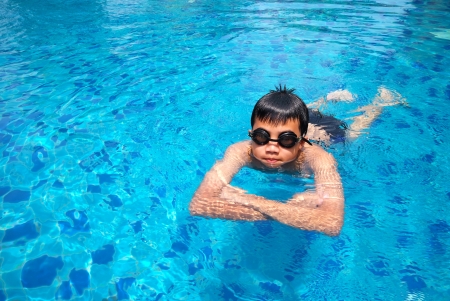 Little boy diving fun in the swimming pool   の写真素材