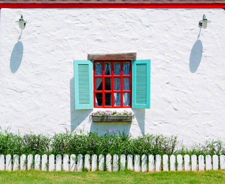 Red and Blue Window with flower pots on the white wall background.の写真素材
