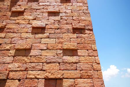 Close up of brick wall background, texture and blue sky