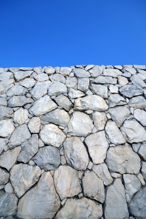 Stone wall background and texture with blue sky の写真素材