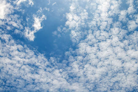 The blue sky and white fluffy clouds .