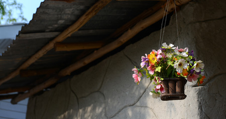 fake flower varicolored in hanging basket for decorative homeの写真素材