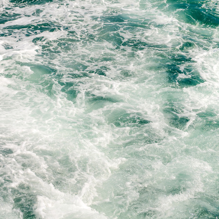 The wake of a boat as seen from the stern of a ship.