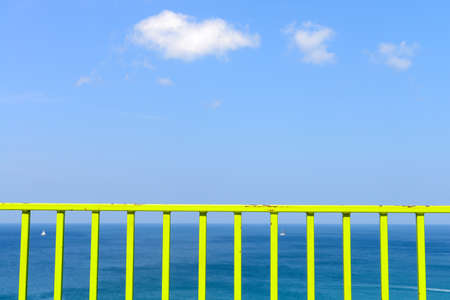 Green iron balconies and tropical beach and blue skyの写真素材