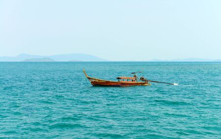 PHUKET, THAILAND - MARCH 24, 2015: Long tail boat on blue water of Andaman Sea in summer at Phuket island. - 24 March 2015, Phuket , Thailand.のeditorial素材