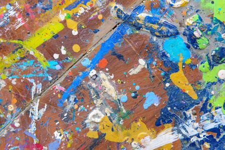 Abstract colorful texture background. Splash acrylic color on wood table.