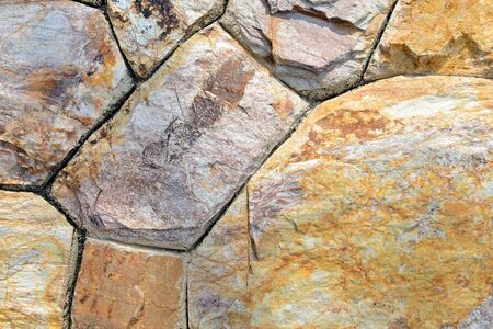 Brown stone wall texture and background