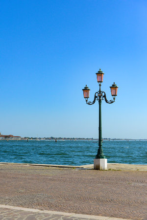 Old street lamp and Grand Canal in Venice, Italy.の写真素材