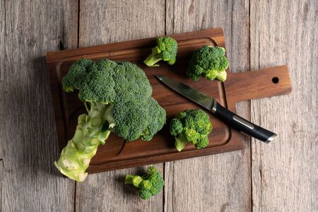 fresh broccoli on wooden cutting boardの写真素材