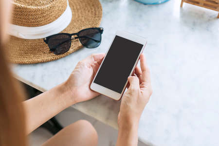 Hands of Asian woman using mobile phone. Relaxation, technology and lifestyle concept. Close up,...