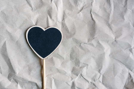 Flat lay of heart on grey crumpled paper. Top view with copy spaceの写真素材