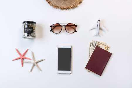 Top view of travel accessories and mobile phone on white color background, travel concept. Flat lay , copy spaceの写真素材